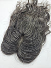 Close-up of natural black and silver gray blend on lace base hair topper