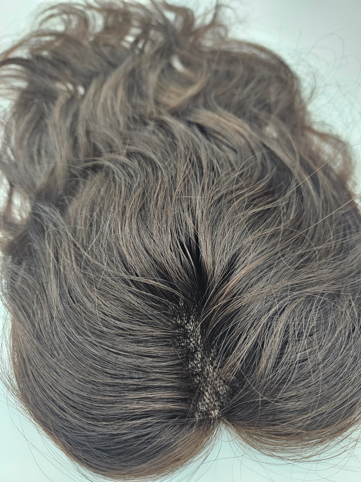 Close-up of brunette Remy hair on lace base topper