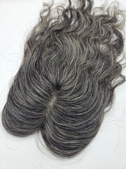 Close-up of natural black and silver gray blend on lace base hair topper