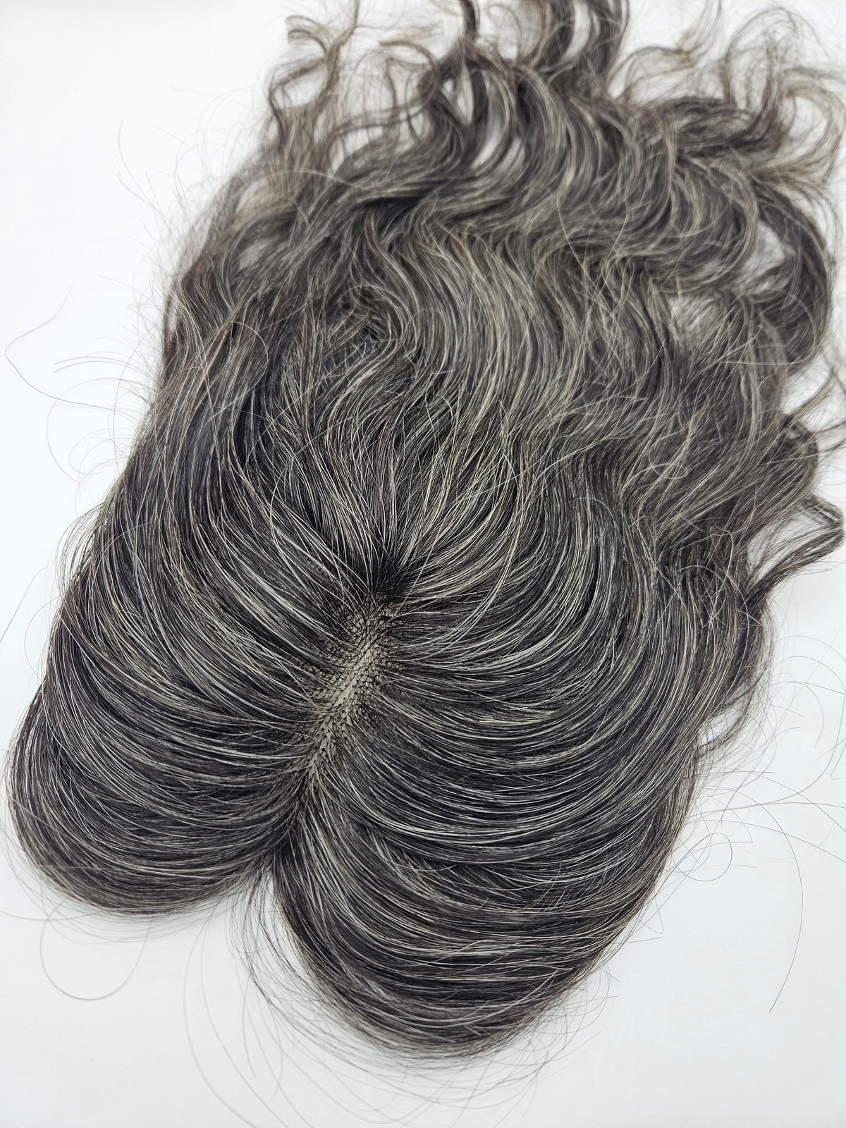 Close-up of natural black and silver gray blend on lace base hair topper