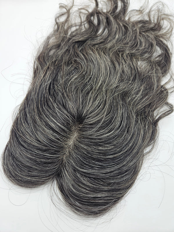 Close-up of natural black and silver gray blend on lace base hair topper